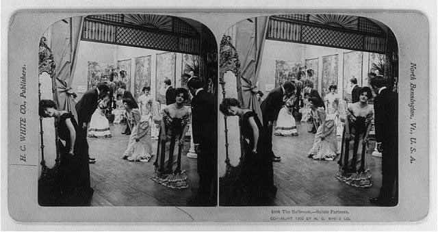 Stereoscopic photograph of a crowded formal ballroom with couples in evening dress greeting each other, 1902.