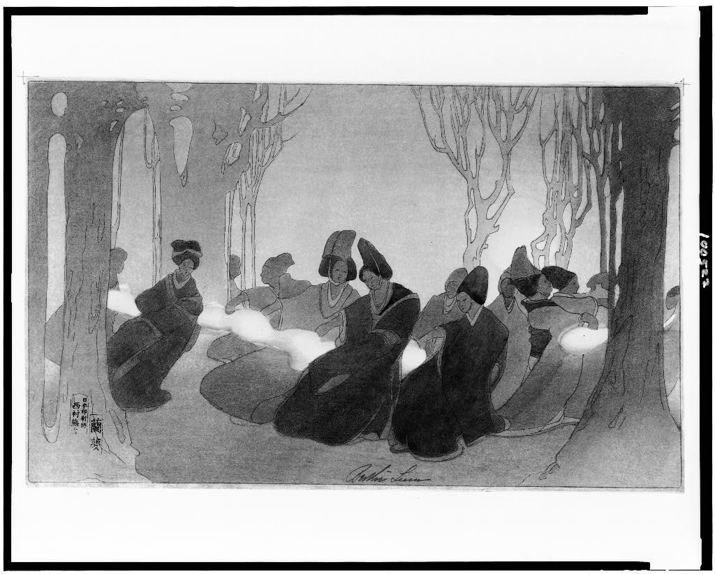 A group of costumed figures in low postures sit facing inward in a woodland setting, wearing distinctive pointed headdresses.