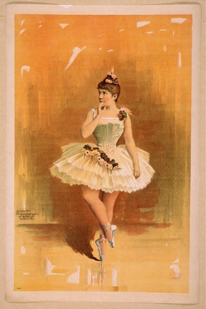 A female ballet dancer in a cream tutu and green bodice stands on pointe in an attitude position against a golden background.
