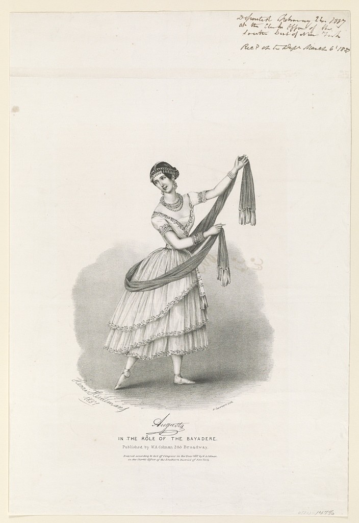 Woman in white muslin dress in 1837, balanced on one leg with arm raised, holding a draped shawl, in theatrical pose.