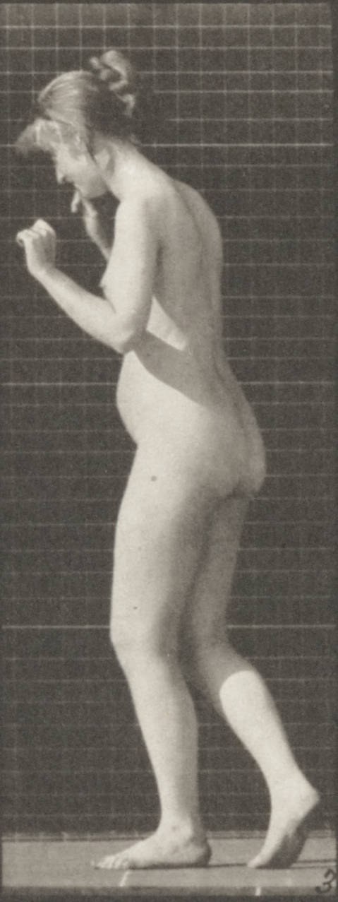 Nude woman in profile against a grid, arm raised, body rotating, captured mid-waltz step.