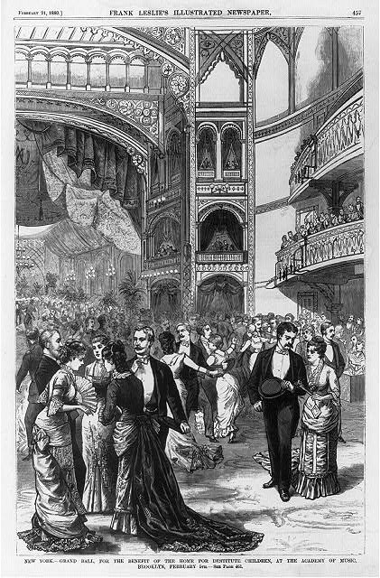 A wood engraving of a formal 1880 ballroom scene showing hundreds of attendees in evening dress gathered in a grand hall with multiple ornate balconies.